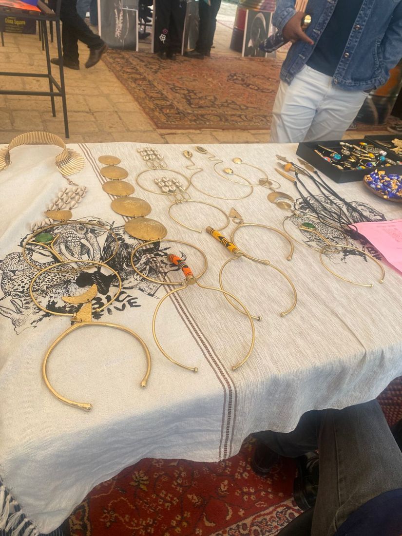 Community members and vendors displaying products and engaging with participants.